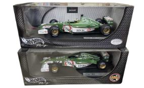 A pair of boxed Hotwheels 1:18 scale model racing cars, to include: - Jaguar Racing. R2, Pedro De La