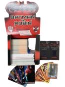 A retail box containing various 1997 Batman and Robin and Batman Returns trading cards, with two