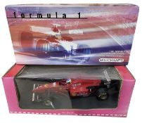 A boxed Minichamps 1:18 scale model, The Michael Schumacher Collection, Ferrari F310 1996
