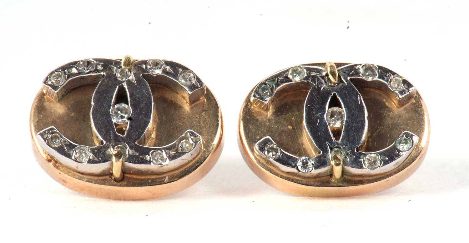 A pair of diamond earrings, the oval discs set with interlocking 'CC' design and set with small - Image 2 of 3