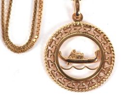 A Venetian pendant and chain, the round pendant with model of a gondola to centre and Greek key
