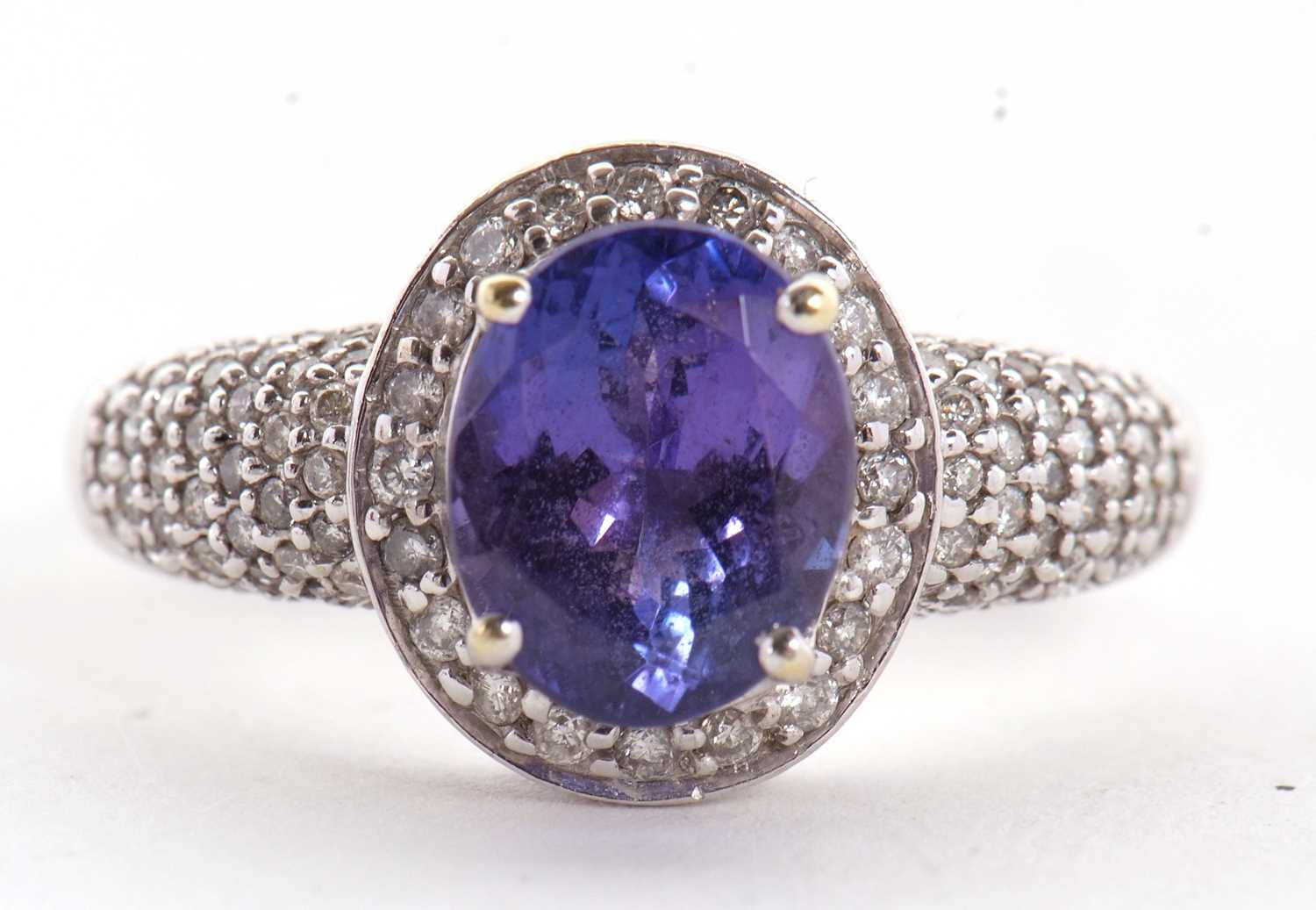 An 18ct white gold tanznite and diamond ring, the oval claw mounted tanzanite, with diamond pave - Image 6 of 9