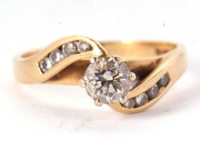 An 18ct diamond ring, the central round brilliant cut diamond, estimated approx. 0.74cts, claw