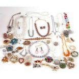 A quantity of costume jewellery to include glass crystal bead necklaces, brooches, diamante, etc