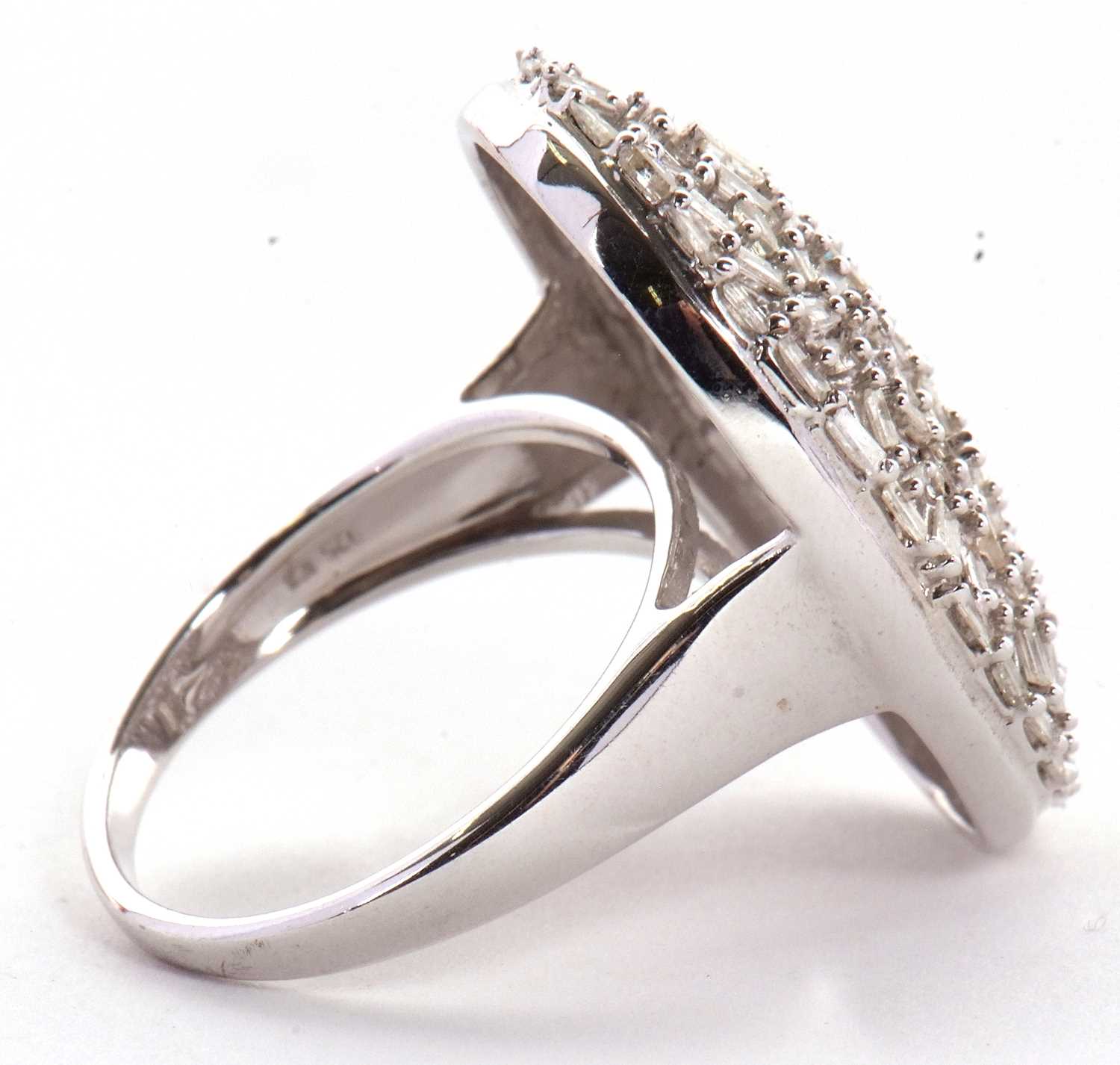 A diamond plaque ring, the oval plaque set with a mix of tapered baguette cut diamonds, totalling - Image 3 of 7