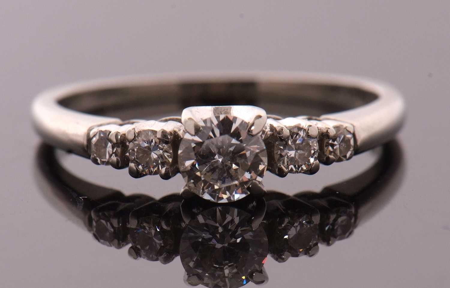 A diamond ring, the central round brilliant cut diamond with a smaller round brilliant and a - Image 2 of 10