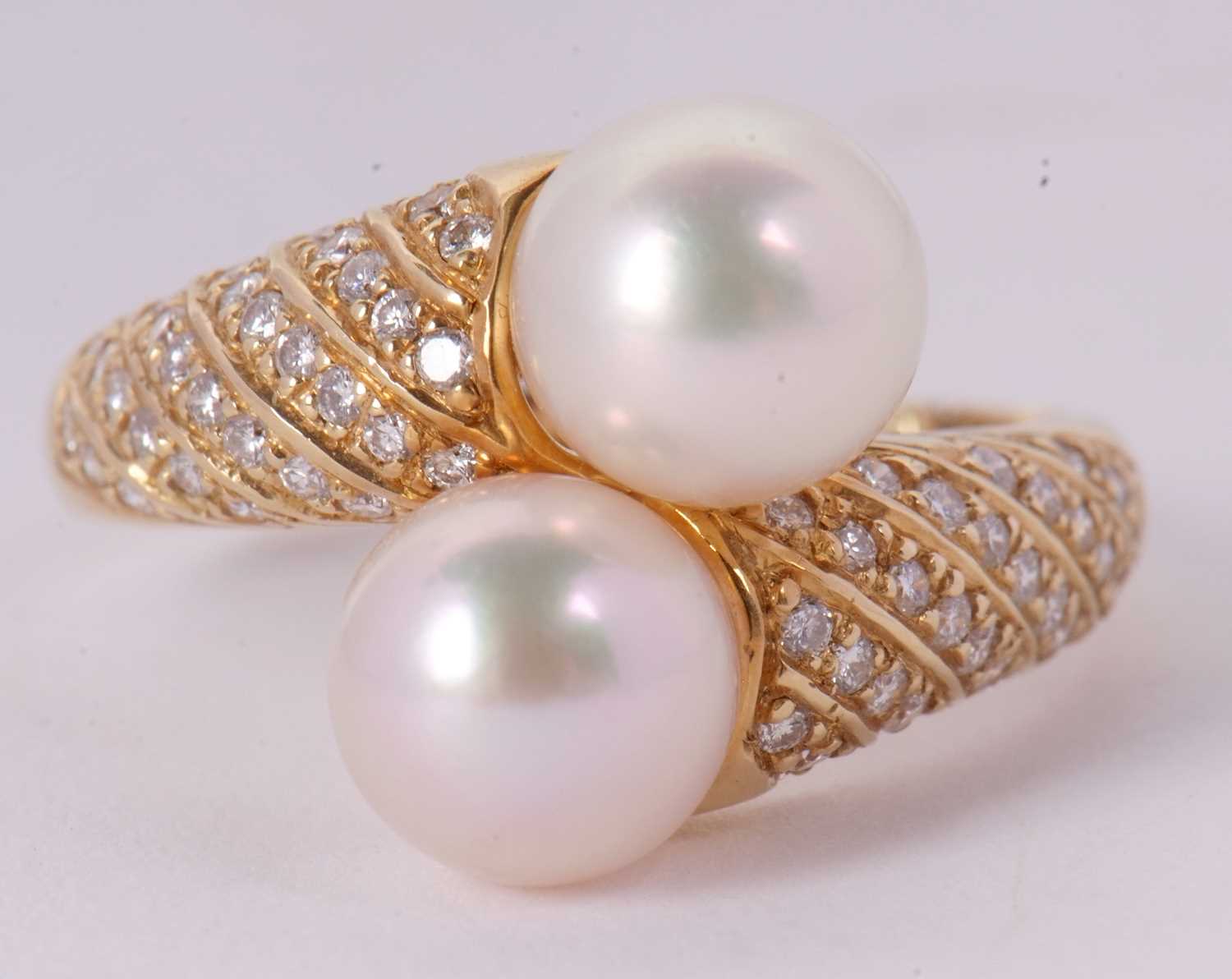 An 18ct cultured pearl and diamond crossover ring, the two cultured pearls set to a half set diamond - Image 2 of 8
