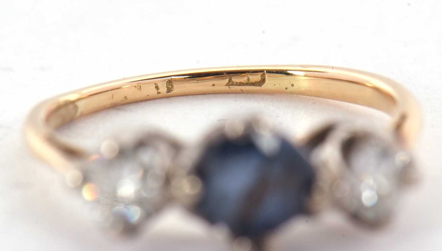 A sapphire and diamond ring, the round mixed cut sapphire set to either side with a round - Image 4 of 7