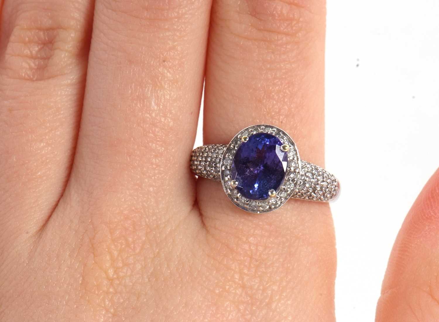 An 18ct white gold tanznite and diamond ring, the oval claw mounted tanzanite, with diamond pave - Image 9 of 9