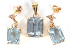 A synthetic blue spinel pendant and earrings, the emerald cut synthetic blue spinel pendant in a