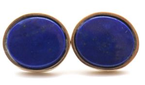 A pair of lapis lazuli earstuds, the oval discs of lapis lazuli in collet mounts and posts for