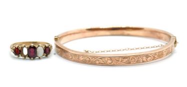 A 9ct bangle and a 9ct ring, the rose gold hinged bangle with engraved decoration to upper half,