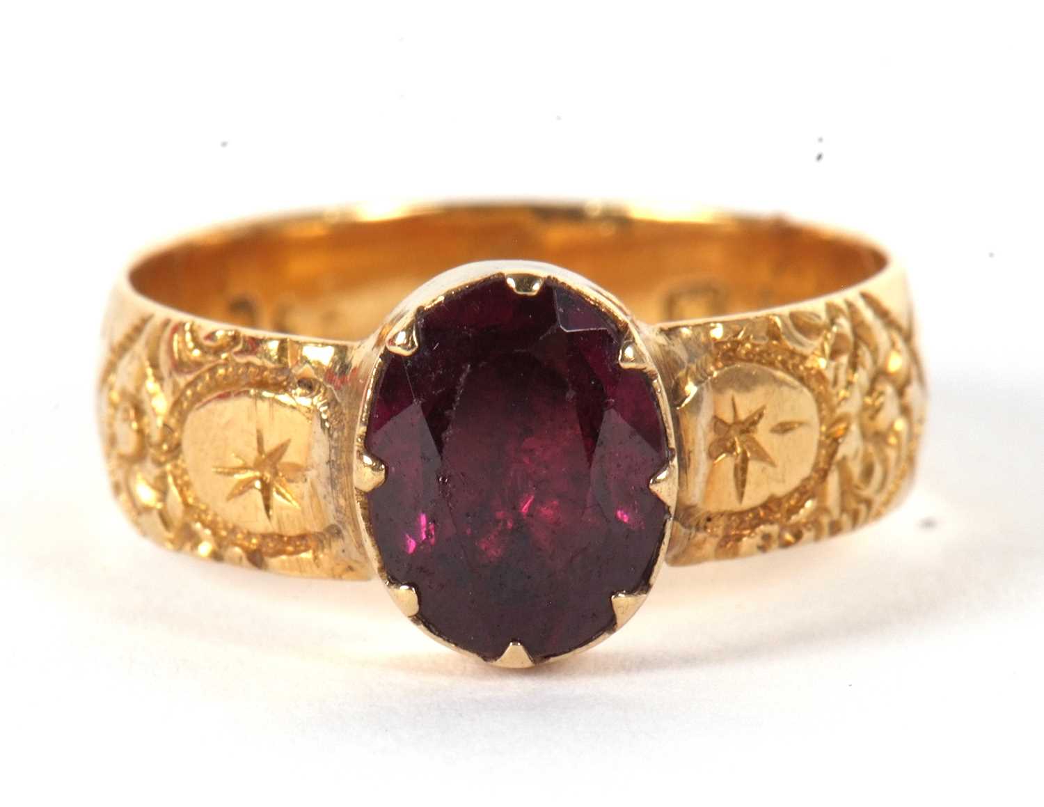 A garnet ring, the oval collet and claw mounted garnet with closed back, with 5.4mm wide band with - Image 2 of 6