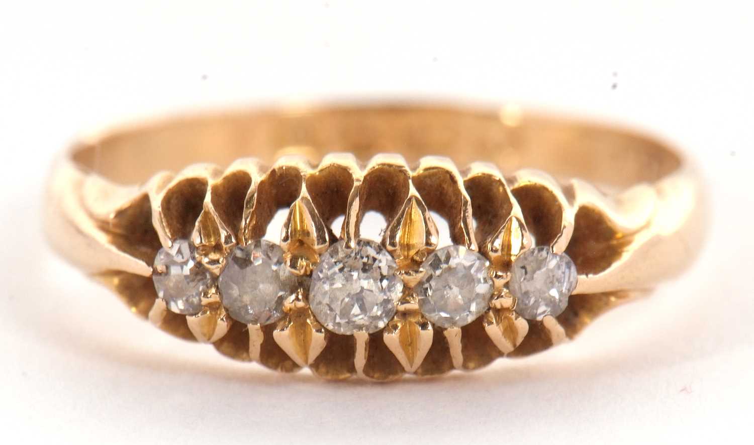 An 18ct diamond ring, the five old mine cut diamonds, all claw mounted to a plain band of yellow