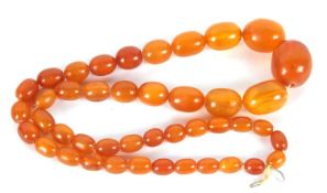 An amber bead necklace, the graduated oval amber beads between 10 - 25mm diameter, approx. 72cm