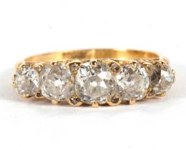 An 18ct five stone diamond ring, the five slightly graudated old mine cut diamonds, total