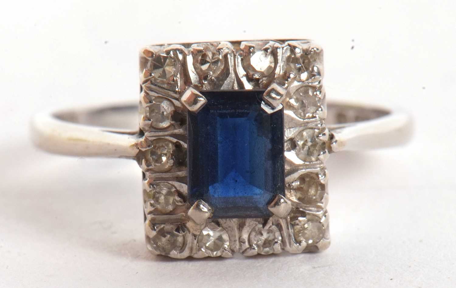 An 18ct sapphire and diamond ring, the rectangular step cut sapphire, surrounded by single cut - Image 5 of 6
