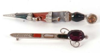 Two agate kilt pins, one in the shape of a sword set with bloodstone and agate with purple paste