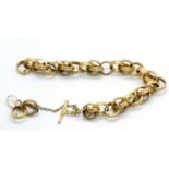 An 18ct fancy link bracelet, the textured round hooped links (test as approx. 18ct gold), with T-bar