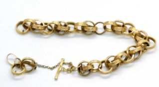 An 18ct fancy link bracelet, the textured round hooped links (test as approx. 18ct gold), with T-bar