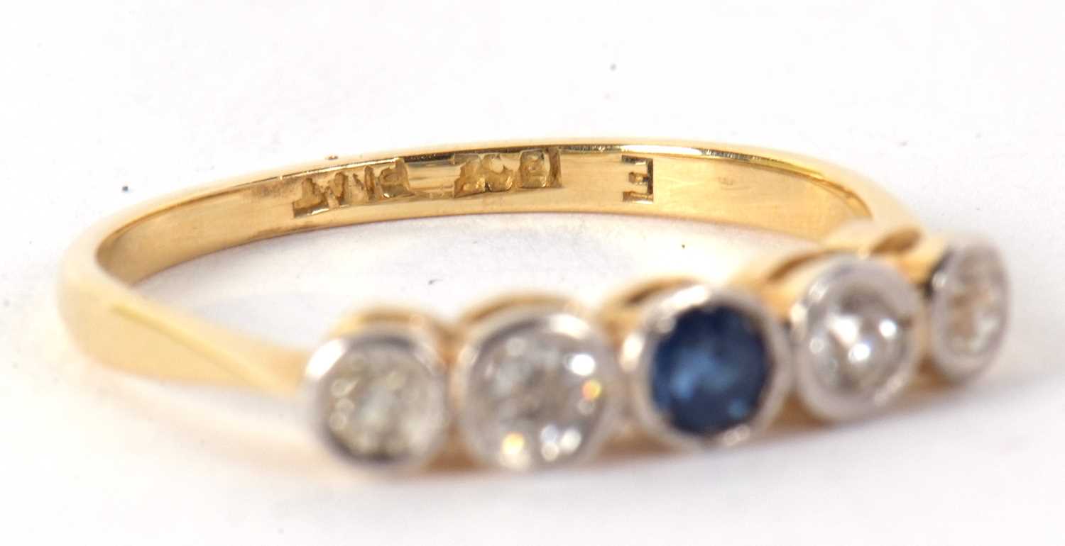 A sapphire and diamond ring, set to centre with a round sapphire and two mixed cut diamonds to - Image 4 of 7