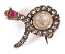 A diamond and ruby snake brooch, the snake set with rose cut diamonds and a single ruby to the head,