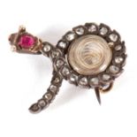 A diamond and ruby snake brooch, the snake set with rose cut diamonds and a single ruby to the head,