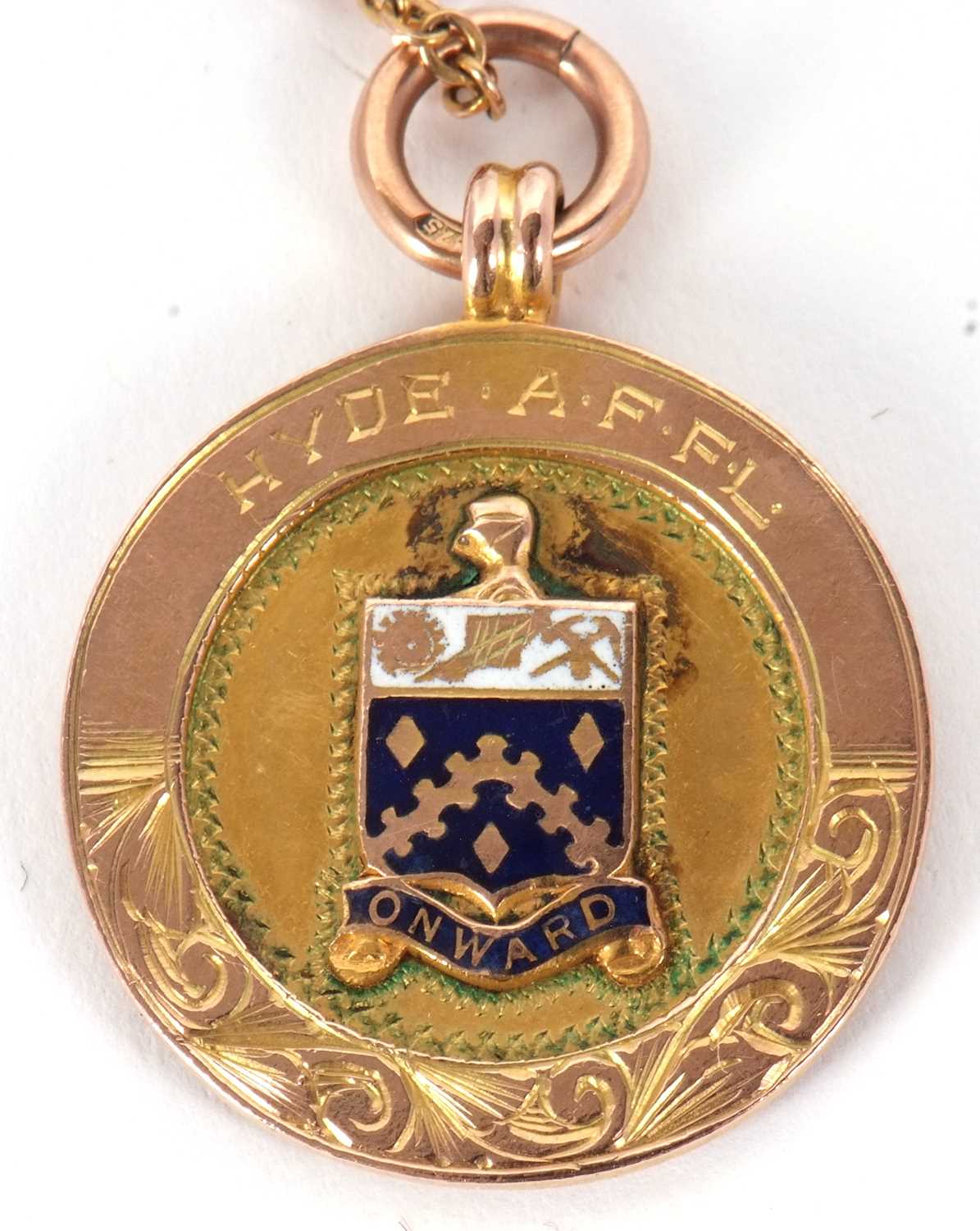 A 9ct 1929-30 Football medallion, the round medallion with enamelled coat of arms to one side and