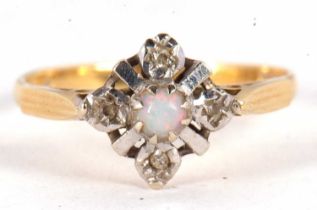 An 18ct opal and diamond ring, the central round opal cabochon set with four small round diamonds,