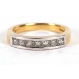 An 18ct diamond ring, with princess cut diamonds, total estimated approx. 0.70cts, channel set in