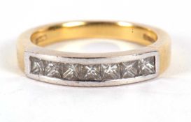 An 18ct diamond ring, with princess cut diamonds, total estimated approx. 0.70cts, channel set in