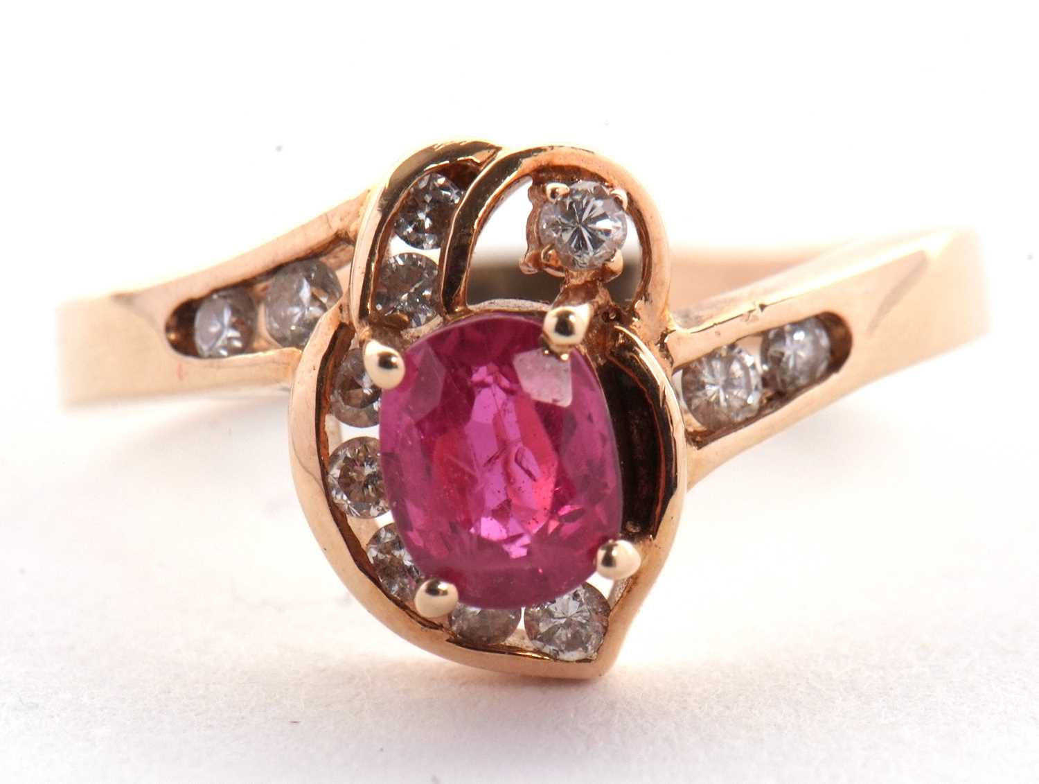 A 14k ruby and diamond ring, the central four claw mounted oval ruby, asymetrically set with small - Image 4 of 4