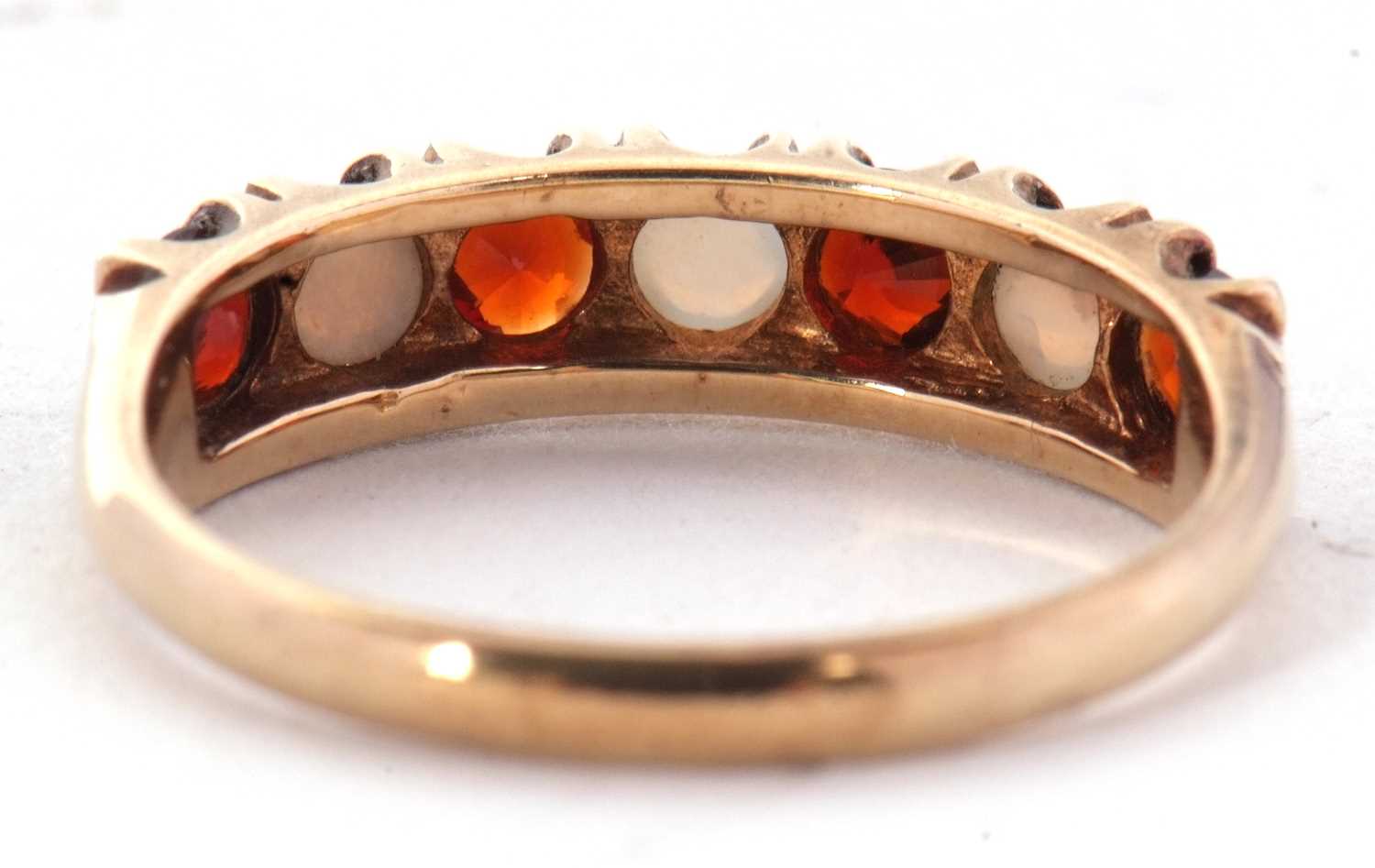 A 9ct garnet and opal ring, set with alternating round garnets and round opal cabochons, all claw - Image 2 of 6
