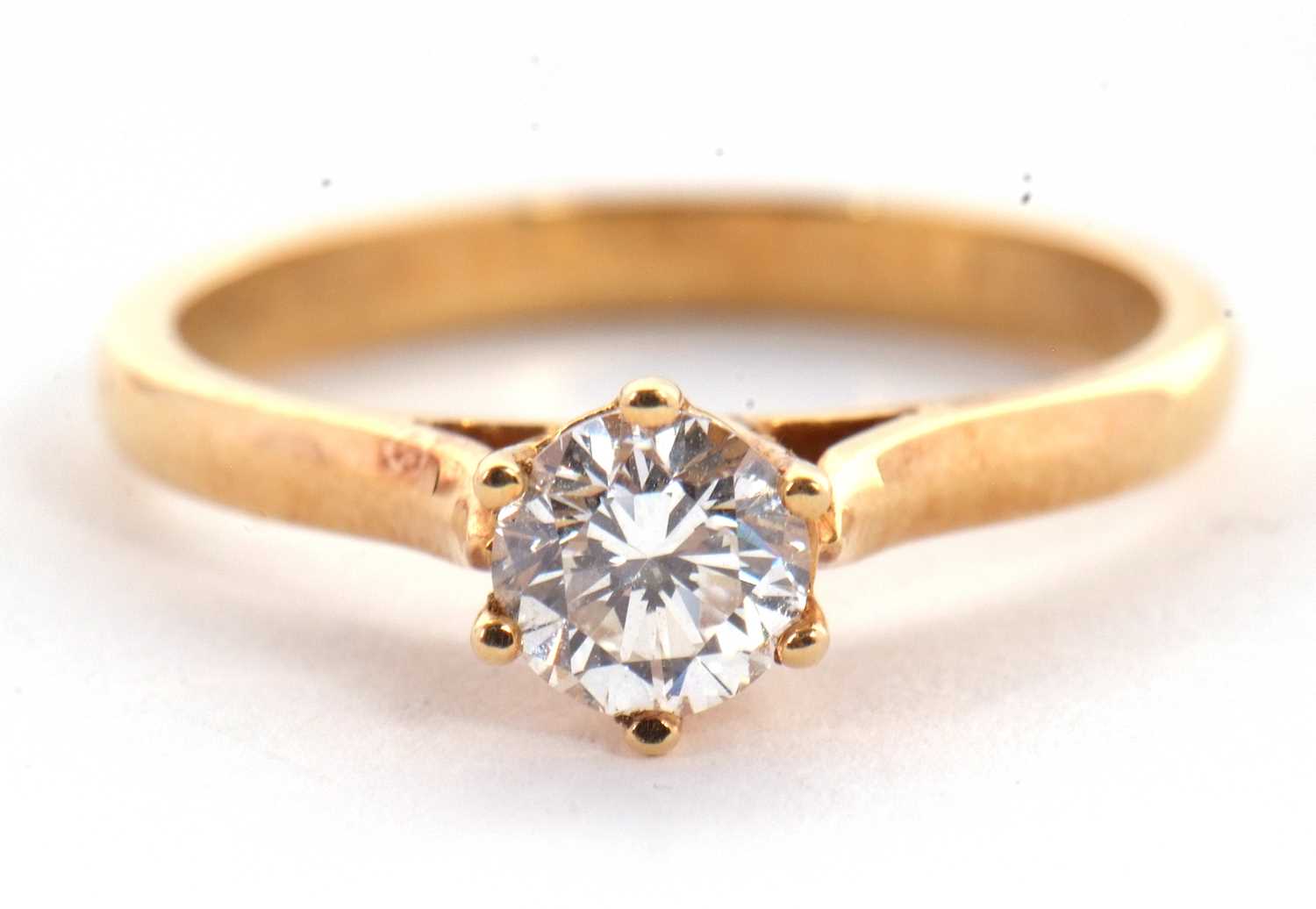 A diamond solitaire ring, the round brilliant cut diamond, stamped .50 to inner band, claw mounted