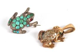 A frog brooch, set with round turquoise cabochons and red eyes, all set in unmarked white metal (