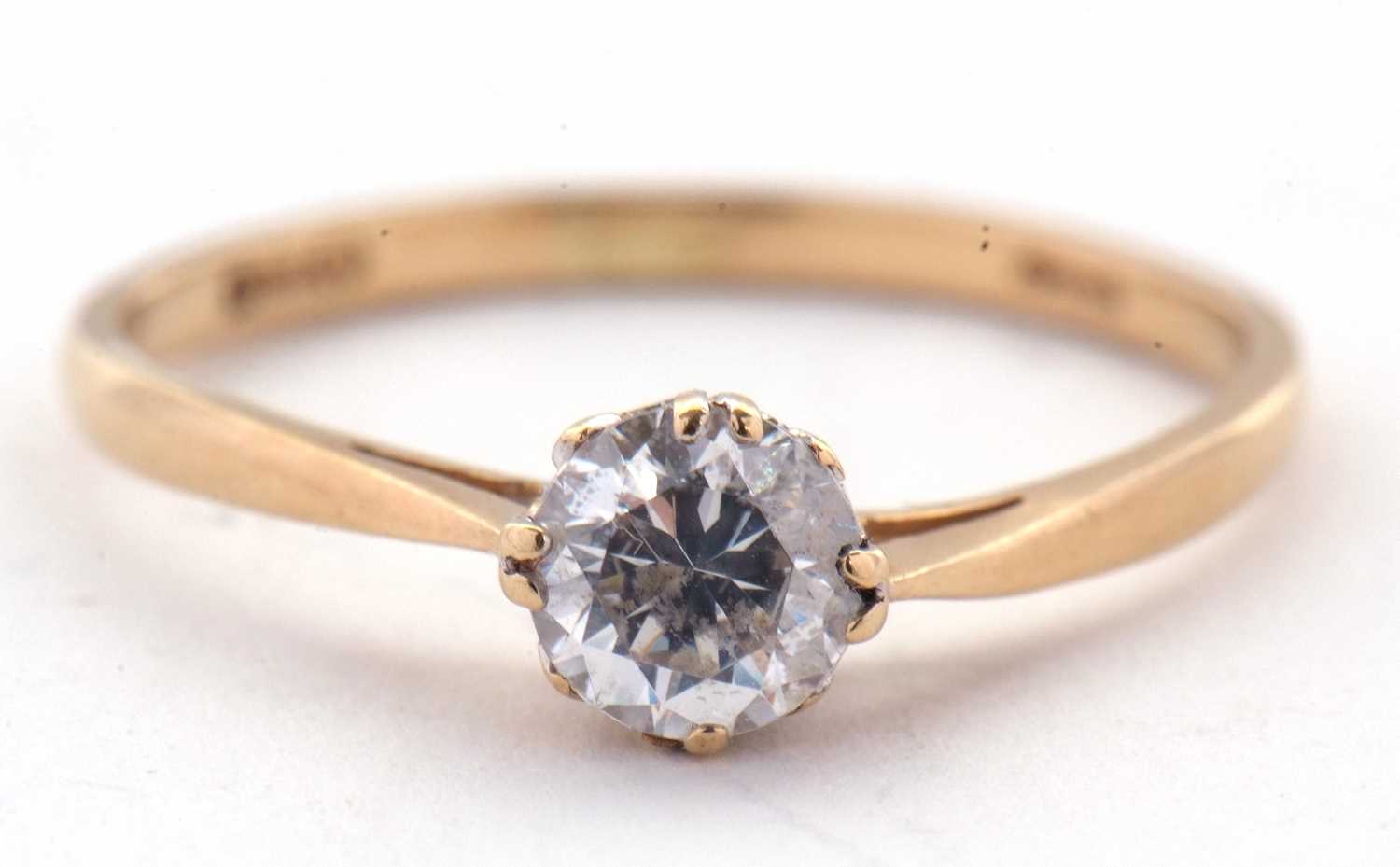 A 14ct CZ ring, the round white CZ claw mounted to a plain band stamped 585 with London assay