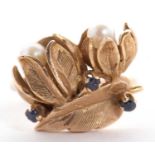 A cultured pearl and sapphire floral ring, the two flowers set with a round cultured pearl to