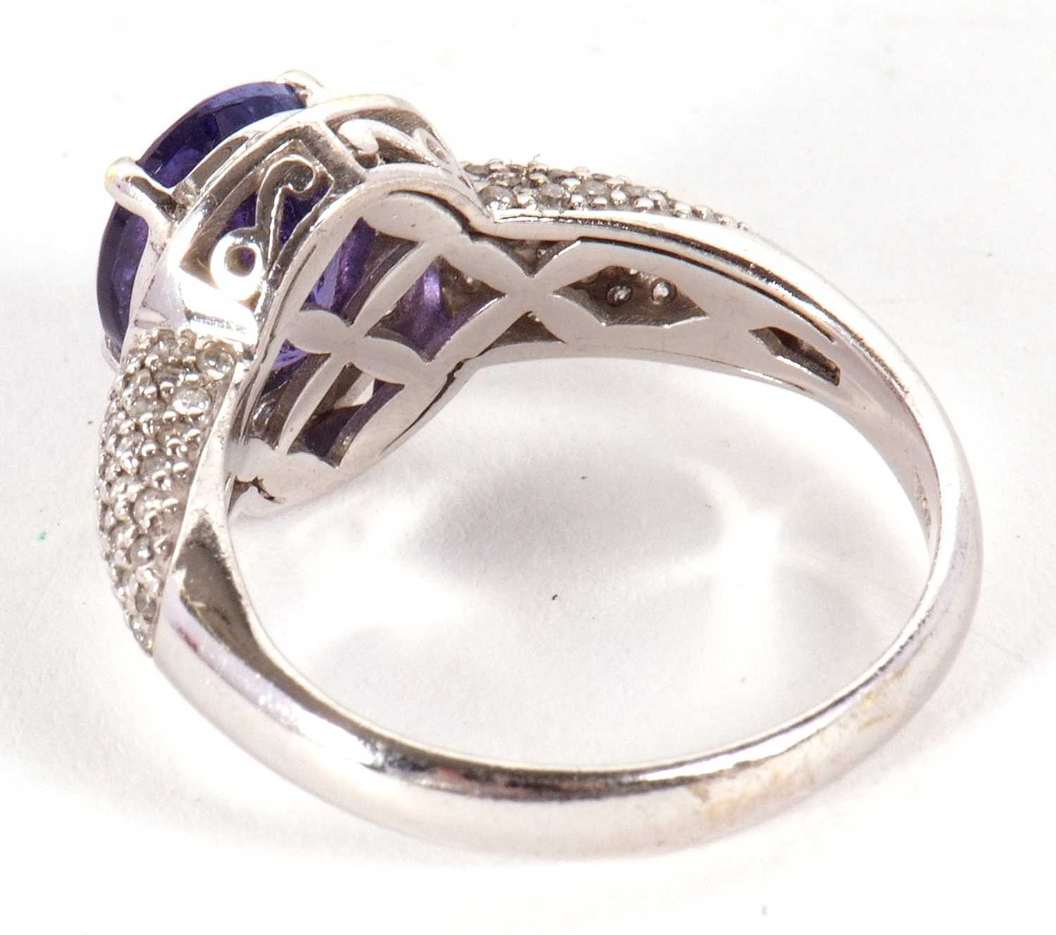 An 18ct white gold tanznite and diamond ring, the oval claw mounted tanzanite, with diamond pave - Image 3 of 9