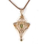 An Edwardian peridot and seed pearl pendant, the central oval peridot in millegrain collet mount,