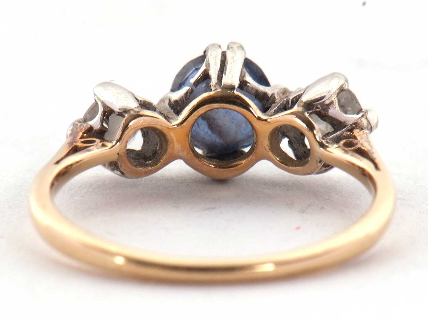 A sapphire and diamond ring, the round mixed cut sapphire set to either side with a round - Image 7 of 7