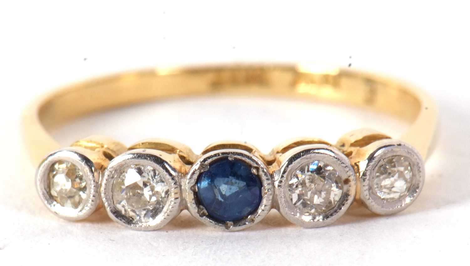 A sapphire and diamond ring, set to centre with a round sapphire and two mixed cut diamonds to - Image 6 of 7