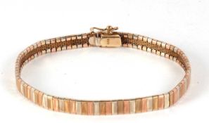 A 9ct tri-colour bracelet, the 6mm wide tri-colour gold bracelet with textured finish, concealed