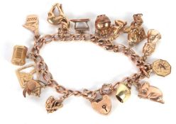 A 9ct charm bracelet, the curblink chain with each link stamped 375, with heart shape padlock