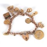 A 9ct charm bracelet, with curblink chain, each link with worn marks, heart shape padlock clasp with