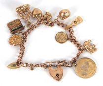 A 9ct charm bracelet, with curblink chain, each link with worn marks, heart shape padlock clasp with