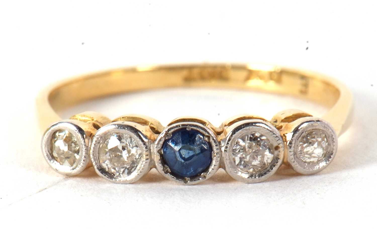 A sapphire and diamond ring, set to centre with a round sapphire and two mixed cut diamonds to - Image 3 of 7