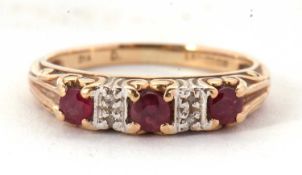 A 9ct ruby and diamond ring, the three round rubies interspaced with two small round diamonds,