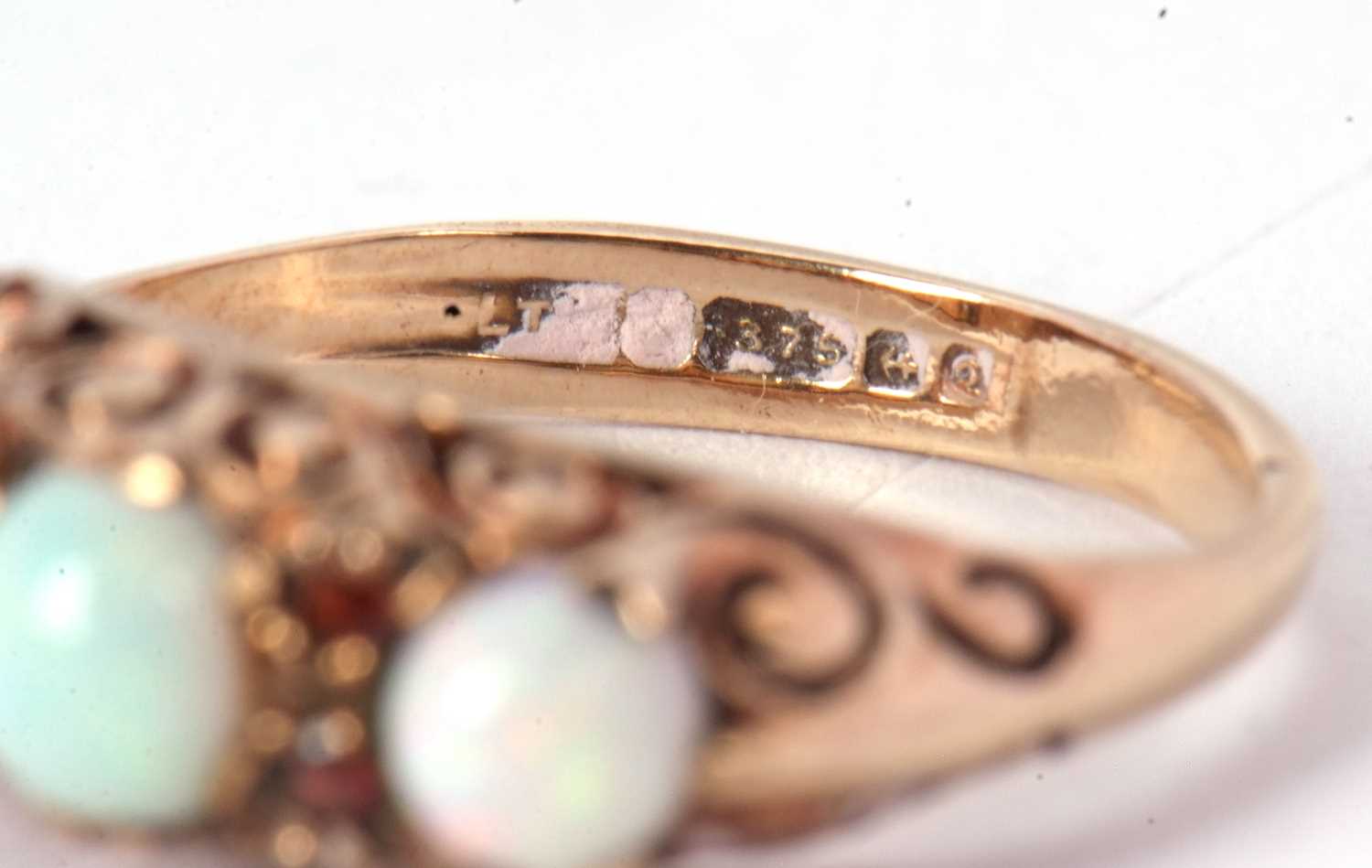A 9ct opal and garnet ring, the three slightly graudated round opal cabochons, interspaced with - Image 5 of 7