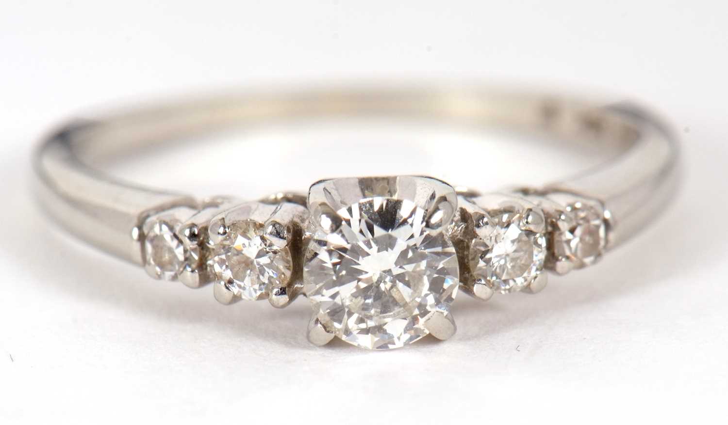 A diamond ring, the central round brilliant cut diamond with a smaller round brilliant and a - Image 4 of 10