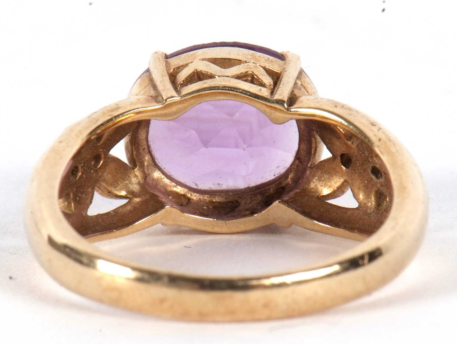 A 9ct amethyst ring, the oval amethyst in a four claw mount, with tapered pierced shoulders set with - Image 4 of 7
